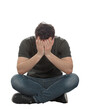 © 1STunningART - Stressed and depressed man seated on the floor covers face feeling desperate and anxious. Male full length portrait isolated on transparent background