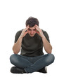 © 1STunningART - Upset and depressed young man sitting on the floor with hands pointed to forehead looking down thoughtful in sorrow, isolated on transparent background with copy space