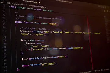 Close-up of PHP Laravel code on a dark editor screen, showcasing user update function and password hashing. Ideal for programming, coding, and web development concepts.
