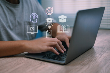 Young adult Gen Z sitting on chair using laptop learning online , search information webpage for education, upskill AI technology course, business, education learning, machine online ,E-learning