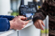 © Austockphoto - coffee van barista with mobile phone doing social media reels post
