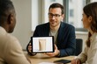 © Who is Danny - Businessman presenting product packaging mockup on tablet during meeting with colleagues in modern office setting with natural light background. Ai generative