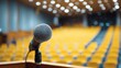 © rinz - A microphone on a stand in a large auditorium.  Blurred background of seats