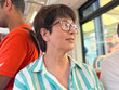 © satura_ - Woman wearing striped shirt and glasses riding public transport. Urban lifestyle, daily commute, and personal perspective in city environment.