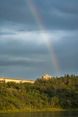 Wall Mural - rainbow is seen in the sky above a mountain