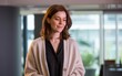 © Vishwesh - Portrait of a woman in a cardigan looking down in an office setting professional shot. woman in a cardigan, looking down thoughtfully in a modern office setting, exuding confidence and elegance.