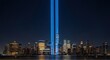 Nighttime city skyline of New York with twin tribute lights shining upward to honor September 11 victims.