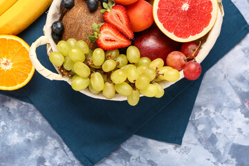 Wall Mural - wicker basket with different fresh fruits on blue background