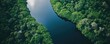 © diwek - Aerial View of a Serene River Flowing Through Lush Green Forest