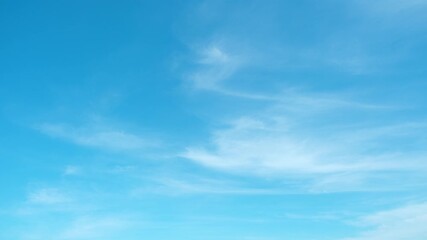 Wall Mural - A timelapse of a blue sky with soft drifting clouds represents the concept of clarity. It also conveys purity of air, peace of mind, environmental balance, and the endless potential of open space.
