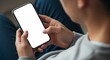 © andrehsnl - Person holds a modern smartphone with a blank white screen in portrait mode.