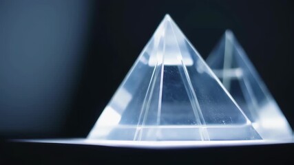 Two Clear Pyramids on Dark Background