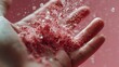 © Juan - Hand holding crushed pink powder with dramatic splash against soft background