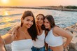 © Bohdan - Friends Taking Selfie at Sunset by the Sea
