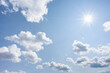 © Tetra Images - Bright sunshine and white puffy clouds in blue sky