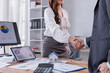 © Tj - Businesswoman shaking hands with a client in a modern office, celebrating the successful signing of a real estate contract for a new home purchase, symbolizing partnership and trust