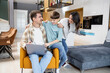 © ivanko80 - Family enjoying time together at home while working and playing in a modern living space