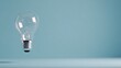 © Sylvia - A glowing lightbulb in a minimalist setting, symbolizing the birth of a new idea or innovation.