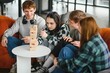 © Serhii - Friends playing engaging board game, having fun together