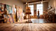 © TyliJura - art studio interior empty wooden table foreground blurred artist workshop background painting easels natural light