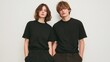 © Newleks - Slim models wearing black t shirts and tailored pants standing close together, creating sleek minimalist aesthetic against clean white backdrop