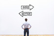 © Song_about_summer - good vs better comparison concept, optimization and improvement, business man looking at arrows on white wall