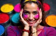 © starush - A woman with colorful face paint smiling joyfully surrounded by vibrant powders