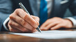 © Rezaul - Signing important documents in an office environment close-up view