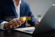 © GamePixel - Businessman pointing at digital target icon on 2026, planning business strategy and future growth with technology concept on laptop screen. leadership and upcoming opportunities.