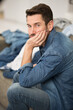 © auremar - depressed man surrounded by a mess of laundry