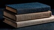 © Toang - Stack of three hardback books with textured covers in shades of blue-gray, beige, and taupe, on a dark surface