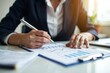 © Vera - Intense Female Auditor Analyzing Financial Documents with Magnifying Glass at Desk in Office