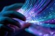 © ariel - Hands touching vibrant fiber optic strands in dark background