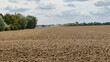 © Florian Dussart - Freshly plowed agricultural field in the countryside under a cloudy sky