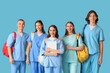 © Pixel-Shot - Group of medical students with backpacks and laptop on blue background
