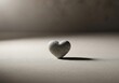 © Sukatno - Minimalist stone heart casting a shadow evoking feelings of love and sentimentality in quiet isolation, the texture