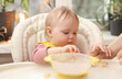 © splitov27 - Cute little baby girl eats at the feeding table