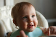 © splitov27 - Portrait of a little baby in a bib at a feeding table