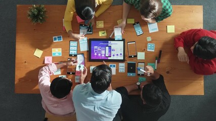 Top view of software developer writing idea about Ux ui design for mobile phone interface. Programmer brainstorm and planning wireframe prototype by looking tablet display smart software. Convocation.