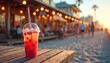 © Maryna - Refreshment on sun-soaked wooden table at beachside boardwalk cafe. Blurred people, shops, and sunset lights create a vibrant summer vacation atmosphere. Enjoying cool drink by the ocean shoreline.