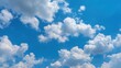 © Ethereal - Serene view of fluffy, cumulus clouds drifting across a clear, vibrant blue sky, creating a peaceful and airy atmosphere