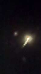 Wall Mural - Vertical time-lapse video of the lunar eclipse of September 8, 2025. The Earth's shadow moves across the upper edge of the Moon, turning it red. The eclipse is called a Blood Moon
