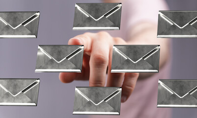Close-up of a hand selecting digital email messages.  Perfect for communication, technology, and inbox concepts.
