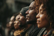 © Lady O - Close-up portrait of a group of Black people standing in a row outdoors, in side view.