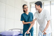 © Chanakon - Physical therapy. Female Nurse aids young man in recovering from spine injury and providing orthopedic massage Orthopedic healthcare and chiropractor with person for physical therapy rehabilitation