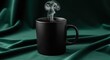 © nad - Steaming black mug stands majestically on draped teal velvet creating moody atmosphere