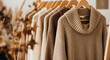 © Anuyj - Close up shot of a row of brown sweaters hanging on wooden hangers in a clothing store