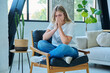 © Valerii Honcharuk - Unhappy upset tired young woman sitting in chair at home