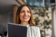 © Dusan Petkovic - Smiling Businesswoman Holding a Tablet in a Bright, Modern Office with Greenery in the Background
