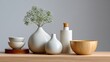 © Jane - A minimalist, clean background of a home goods store with a few simple ceramic vases and bowls.